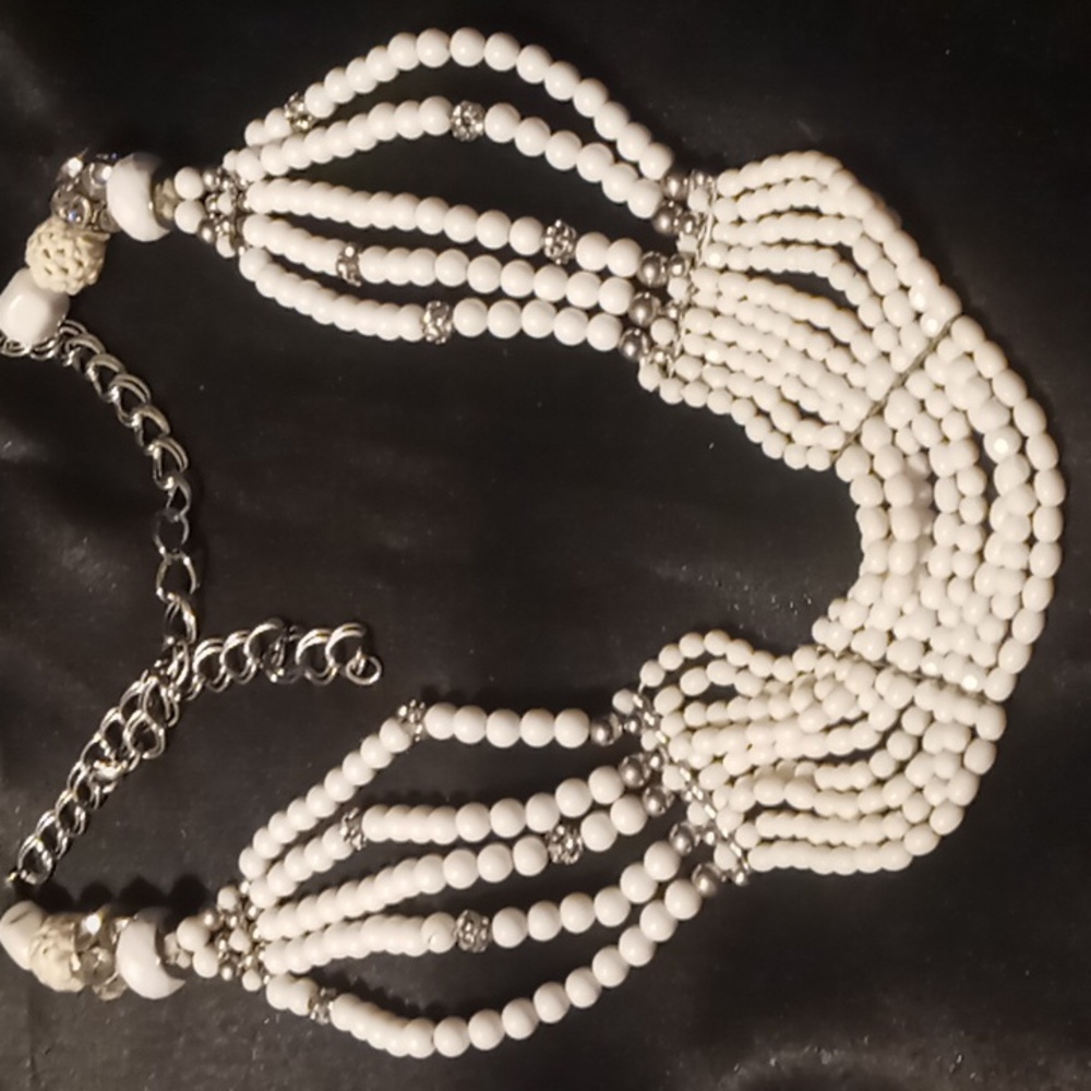 White layered beaded 32 in. or shorter bib necklace.
